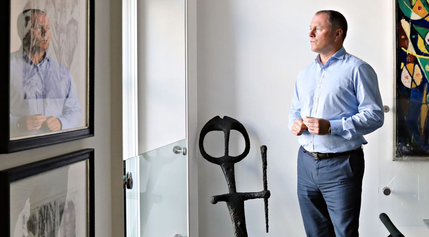 Nicolay Tangen looking out the window in his office