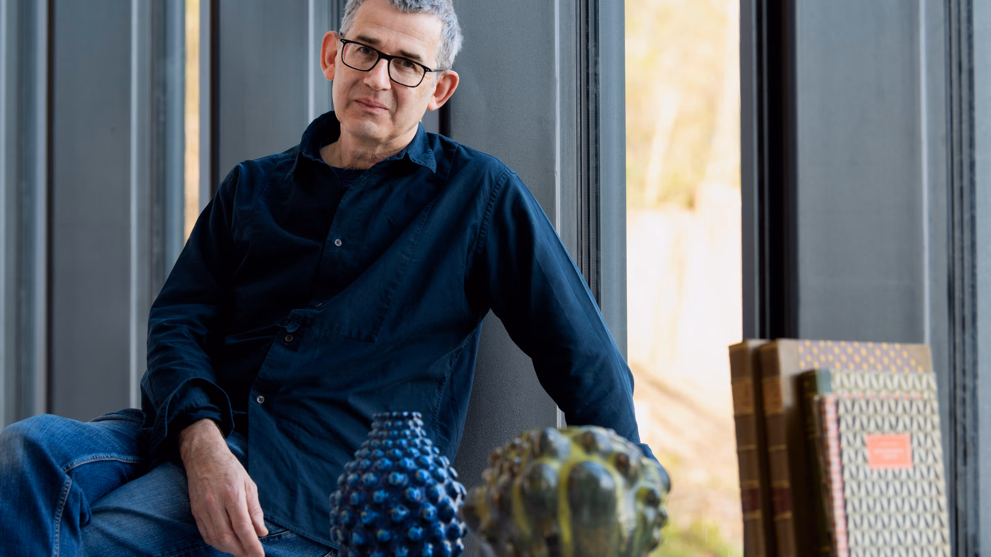 Edmund de Waal surrounded by Axel Salto’s work at CLAY Museum of Ceramic Art Denmark. Photo by Peter Leth-Larsen © Axel Salto/VISDA