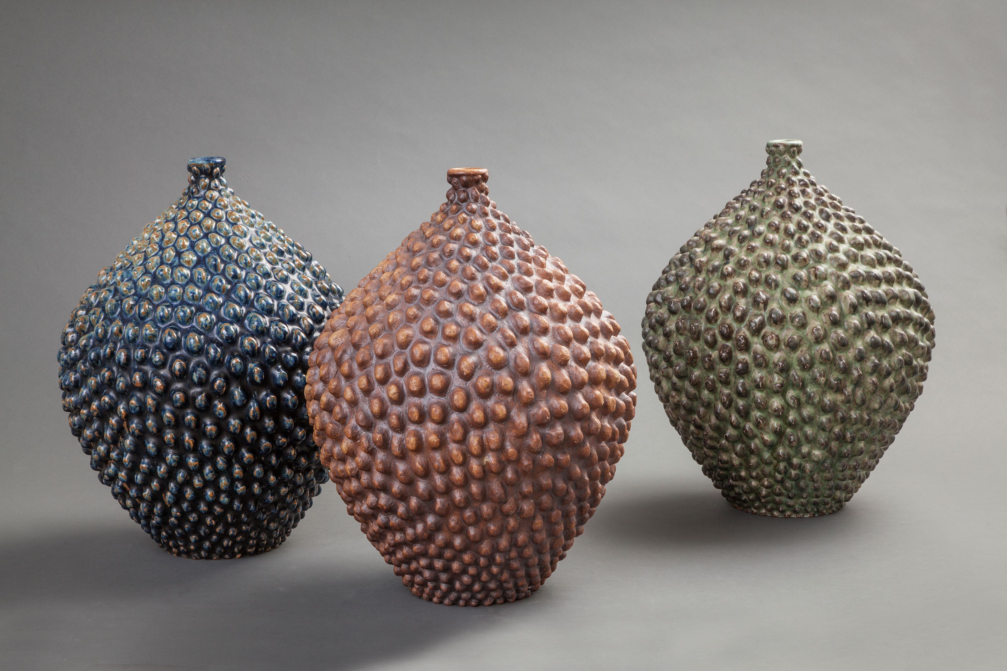 Axel Salto. Three vases in budding style . 1958, 1954, 1958. Stoneware. Various glazes. CLAY - The Royal Copenhagen Collection Foto by Ole Akhøj © Axel Salto/VISDA